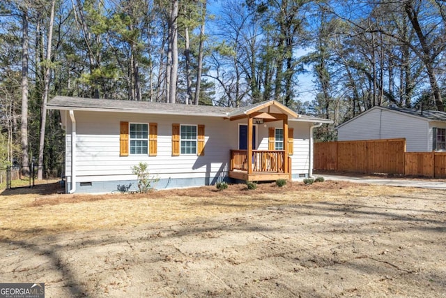 view of front of house featuring crawl space and fence