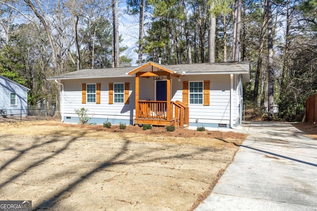 view of front of home with fence, driveway, and crawl space