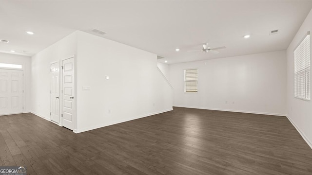 unfurnished room with dark wood-style floors, recessed lighting, visible vents, ceiling fan, and baseboards