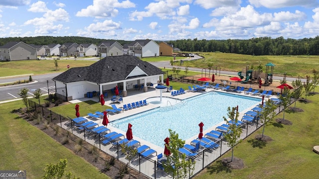 pool featuring a yard, fence, and a patio