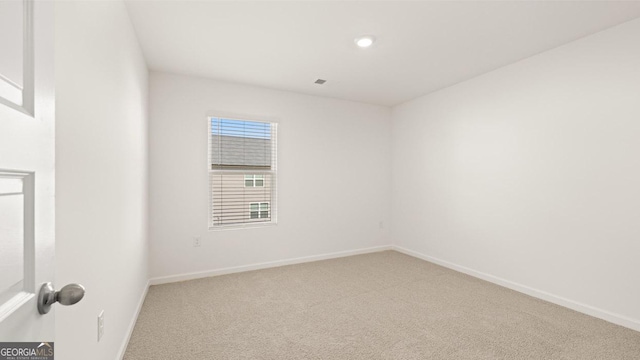 carpeted empty room with baseboards