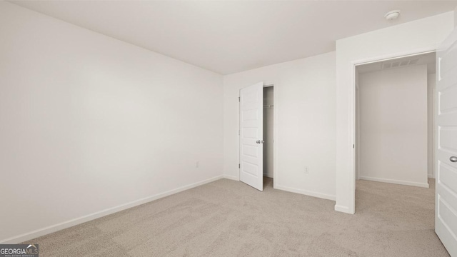 unfurnished bedroom with baseboards and light colored carpet