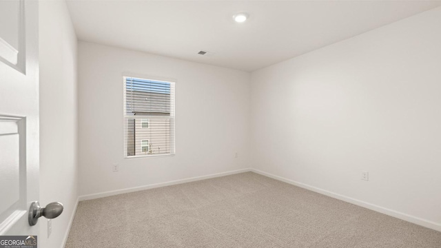 empty room featuring carpet floors and baseboards