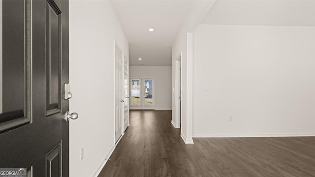 corridor featuring dark wood-style floors, recessed lighting, and baseboards