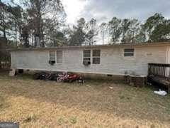 rear view of house with a yard