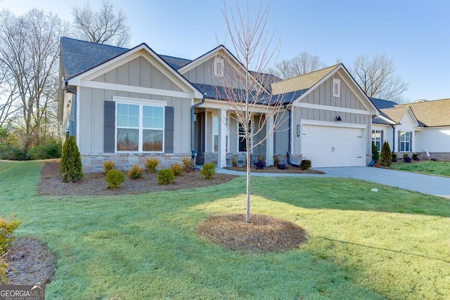 craftsman-style house featuring a shingled roof, concrete driveway, an attached garage, board and batten siding, and a front lawn