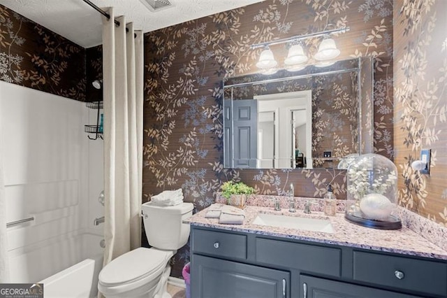 full bathroom with wallpapered walls, shower / bath combo, toilet, a textured ceiling, and vanity