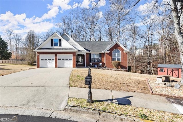 view of front of house with concrete driveway, an attached garage, a storage unit, an outdoor structure, and brick siding