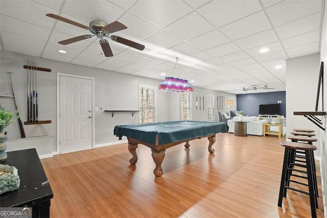 recreation room featuring pool table, a drop ceiling, wood finished floors, and baseboards