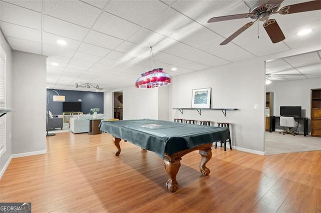 recreation room with a paneled ceiling, baseboards, wood finished floors, and recessed lighting