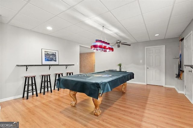 rec room with a drop ceiling, billiards, baseboards, and wood finished floors