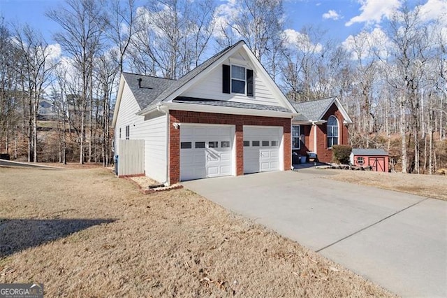 view of side of property featuring driveway, a yard, a garage, and brick siding