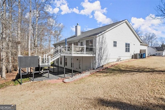 view of home's exterior with central air condition unit, a wooden deck, a chimney, and a yard