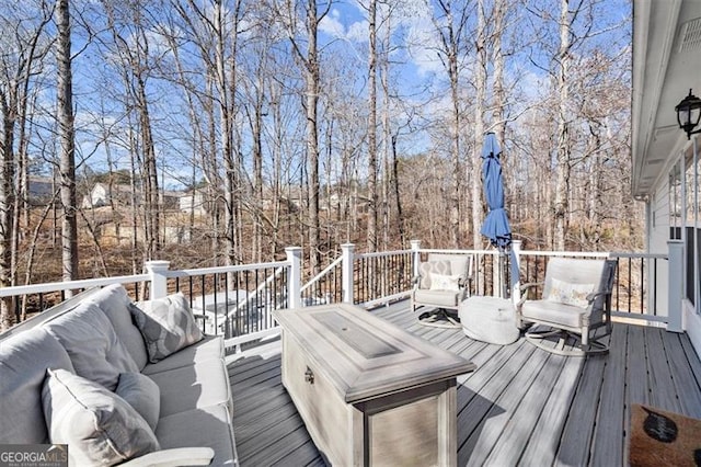 snow covered deck featuring an outdoor living space