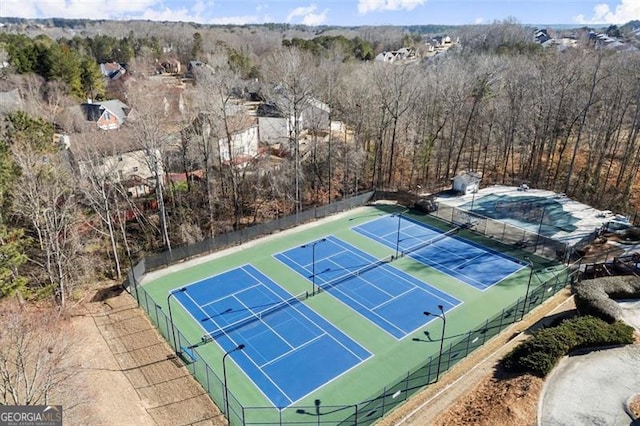 view of sport court featuring fence