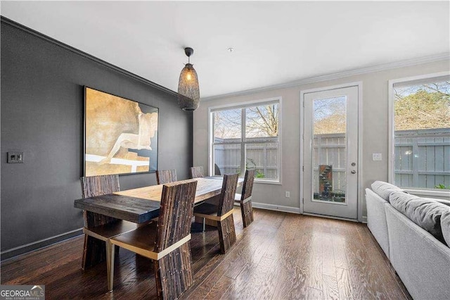 dining space featuring crown molding, baseboards, and dark wood-style flooring