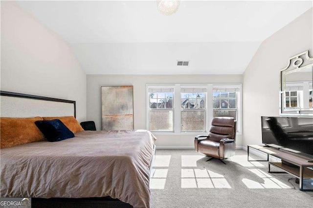 bedroom with vaulted ceiling, baseboards, visible vents, and light colored carpet