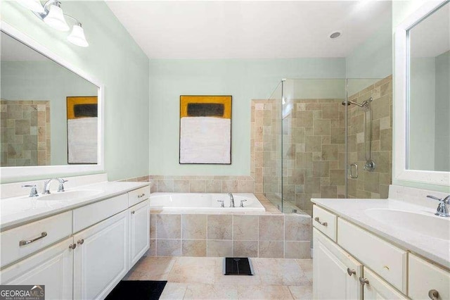 bathroom with a bath, a stall shower, two vanities, and a sink