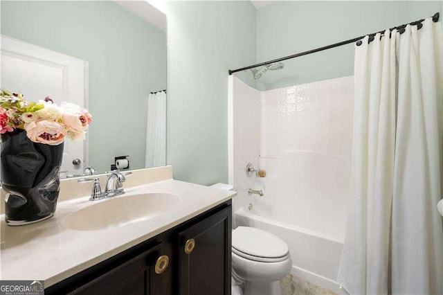 bathroom featuring vanity, shower / bath combo with shower curtain, and toilet