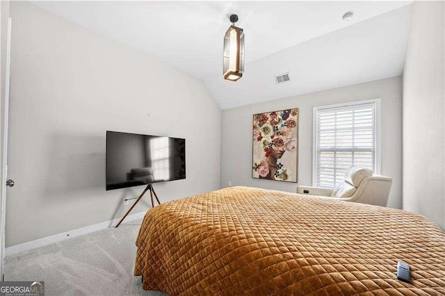 carpeted bedroom with baseboards, visible vents, and vaulted ceiling