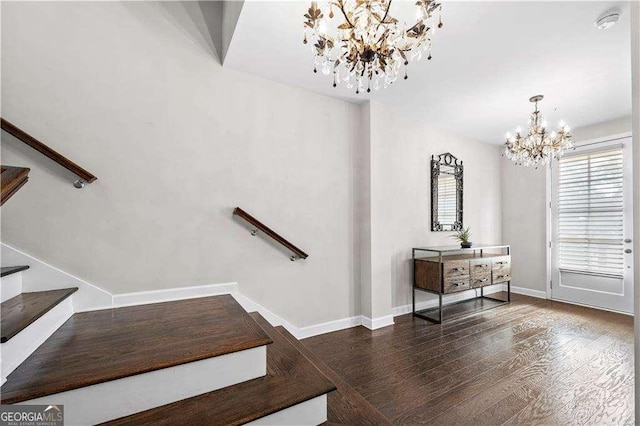 stairs featuring a notable chandelier, baseboards, and wood finished floors