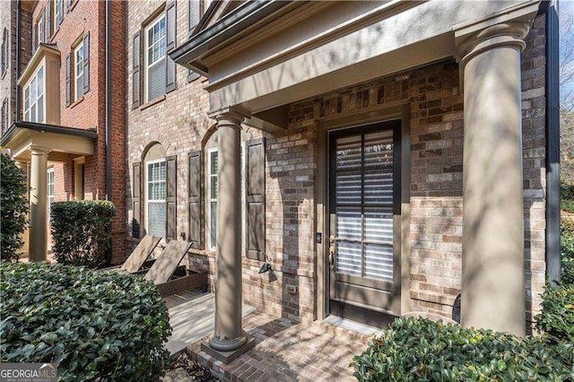 property entrance with brick siding