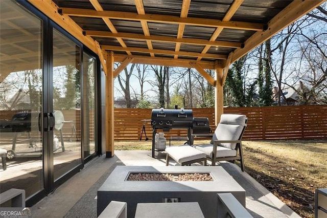 view of patio featuring an outdoor fire pit, a fenced backyard, and a grill