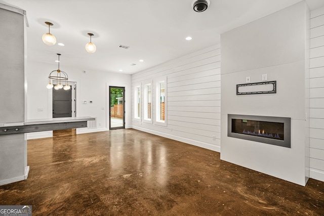 244 Locust St Unit B, Atlanta, GA 30317 - unfurnished living room with finished concrete floors, a glass covered fireplace, and recessed lighting