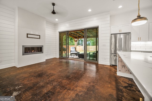 244 Locust St Unit B, Atlanta, GA 30317 - unfurnished living room with concrete floors, a glass covered fireplace, ceiling fan, and recessed lighting