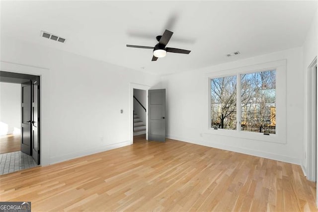 interior space with visible vents, baseboards, and wood finished floors