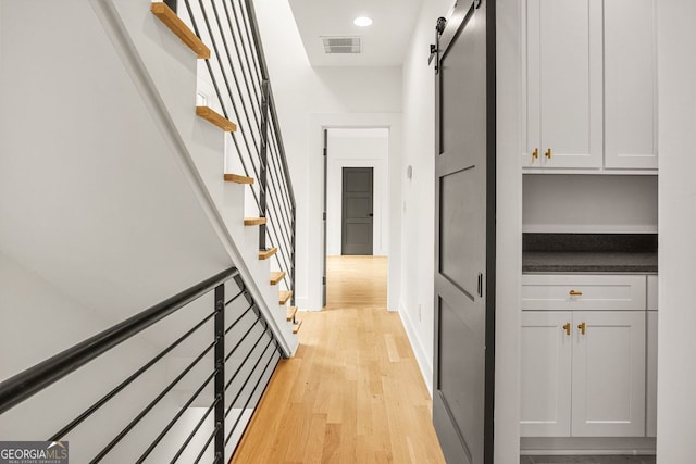 244 Locust St Unit B, Atlanta, GA 30317 - corridor with a barn door, light wood finished floors, stairway, baseboards, and recessed lighting