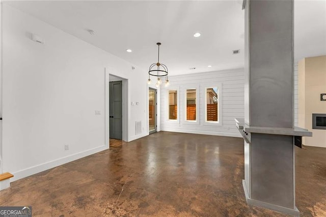 unfurnished living room with baseboards, visible vents, concrete flooring, and recessed lighting