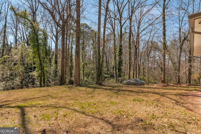 view of yard with a forest view