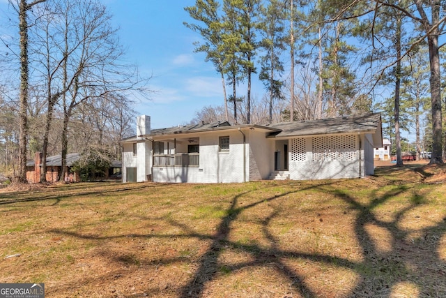 exterior space with brick siding and a front lawn