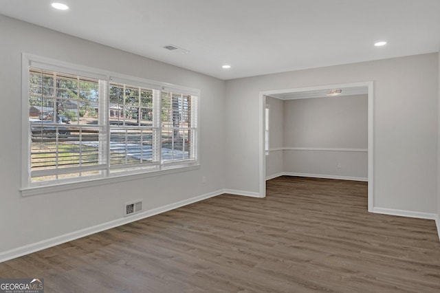 unfurnished room featuring visible vents, recessed lighting, baseboards, and wood finished floors