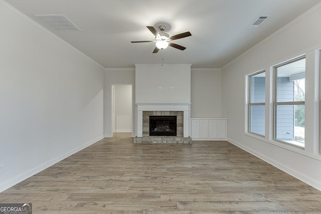 unfurnished living room featuring light wood finished floors, ornamental molding, and visible vents