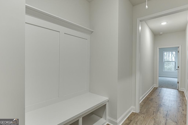 mudroom with baseboards and light wood-style floors