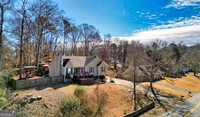 exterior space with a chimney and fence