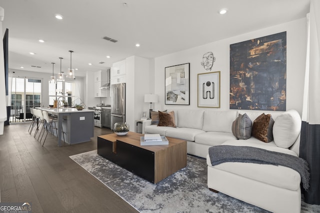 living area featuring visible vents, dark wood-style flooring, and recessed lighting