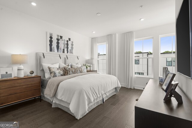 bedroom featuring baseboards, dark wood-type flooring, and recessed lighting