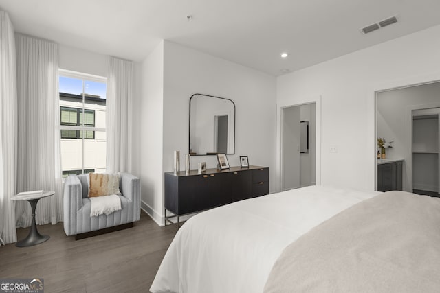 bedroom with dark wood-style flooring, visible vents, and recessed lighting