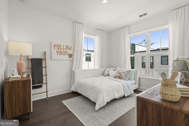 bedroom with dark wood-type flooring, visible vents, and baseboards