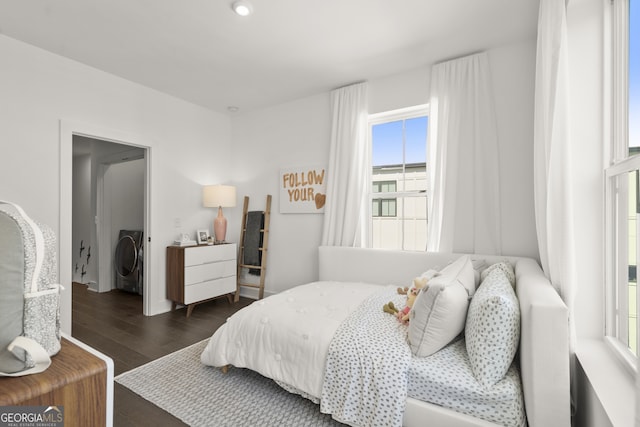 bedroom featuring washer / clothes dryer and dark wood finished floors