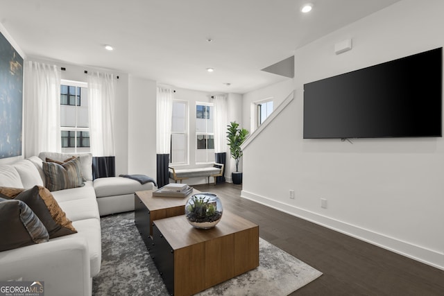 living room featuring baseboards, dark wood-style flooring, and recessed lighting