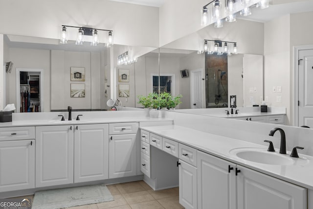 full bath with a sink, a spacious closet, and double vanity