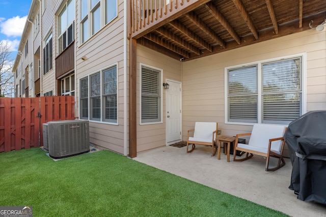 view of patio featuring fence, grilling area, and central AC