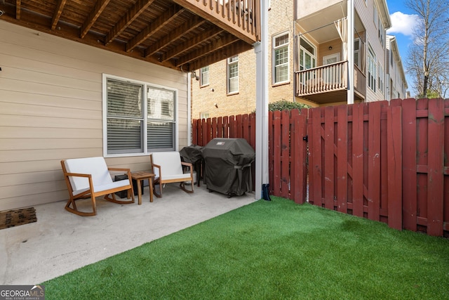 view of patio featuring fence and area for grilling