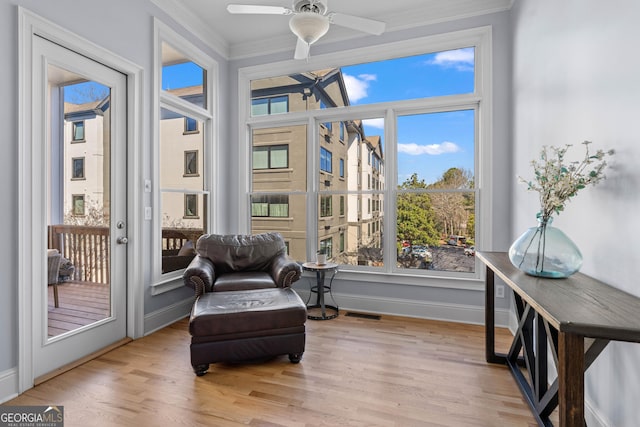 sunroom / solarium with visible vents and a ceiling fan