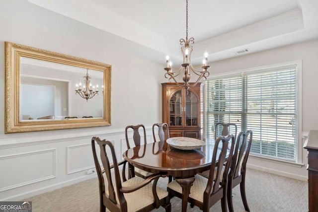 dining space featuring a chandelier, carpet flooring, a raised ceiling, and visible vents