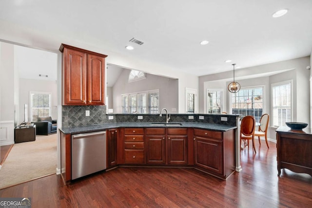 kitchen featuring decorative light fixtures, visible vents, decorative backsplash, stainless steel dishwasher, and a sink